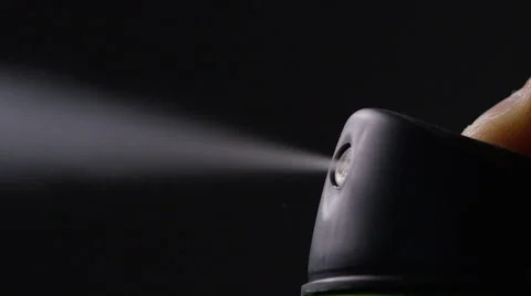 Aerosol can being sprayed against a black background, in slow motion at 240fps Stock Footage 57643289