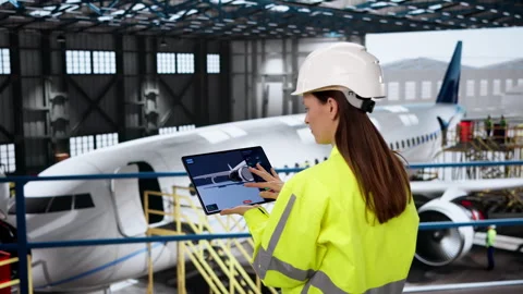 Aerospace Engineer Carefully Inspects Plane Engine Using Tablet Video stock 331523618