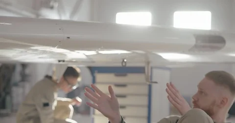 Aerospace engineer getting under airplane wing Stock Footage 104662543