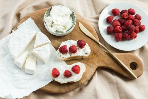 Aesthetic breakfast camembert, cream cheese and raspberries Stock Photos