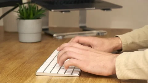 Aesthetic close up shot on typing hands with a background laptop and plant Stock Footage 142610848