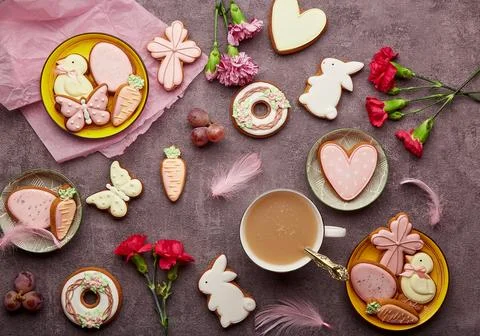 Aesthetic Easter background complete decorated cookies, coffee cup, feathers and Stock Photos