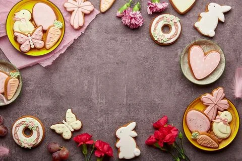 Aesthetic Easter background with copy space - decorated cookies, aster flowers Stock Photos