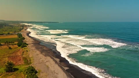 Aesthetic Green Ocean Waves Rolling Along Tropical Coast Aerial View Video stock 337475743
