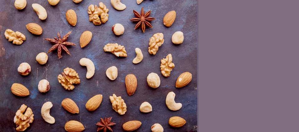 Aesthetic repeated pattern with assorted nuts, raisins and cranberries on rustic Stock Photos