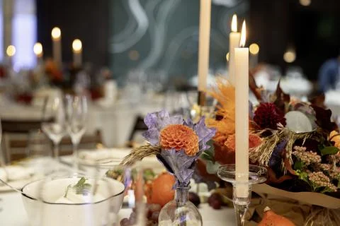 Aesthetic stylish autumn table setting background, arranged flowers and candl Stock Photos