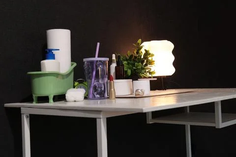 Aesthetic vanity table setup with skincare and makeup essentials illuminate.. Stock Photos