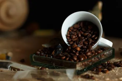 An aesthetically pleasing view of coffee beans beautifully spilling from a cl Stock Photos