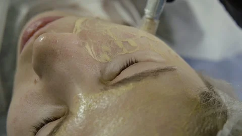 Aesthetician is performing micro needling procedure on female face skin for Stock Footage 106265527
