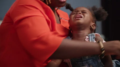 Affection, African mother plaiting her daughter's hair at home. Video stock 346001833