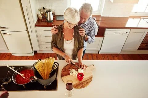 Affection, support or old couple kitchen cooking with love or healthy food for Fotos Stock
