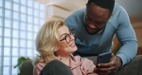 Affectionate Afro-American boyfriend sharing social media content with nice Video stock 123671963