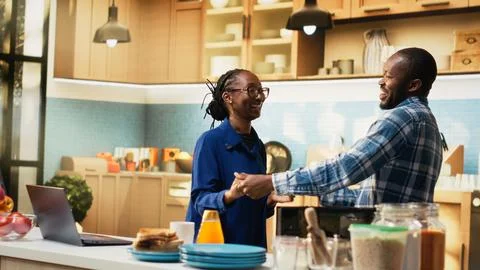 Affectionate black couple sharing a cute waltz in the kitchen Fotos Stock
