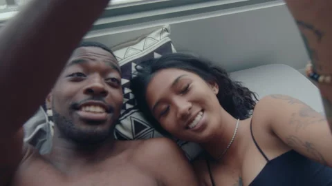 Affectionate Boyfriend and Girlfriend Touching Hands in Bed Stock Footage 236683053