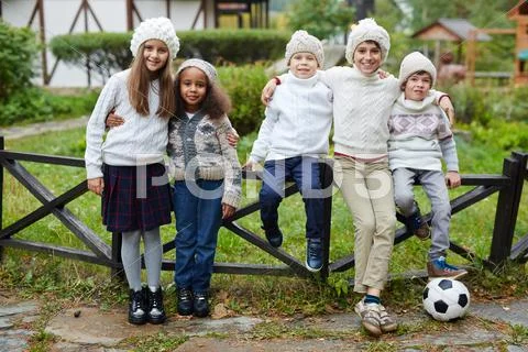 Affectionate classmates looking at camera in natural environment Stock Photos