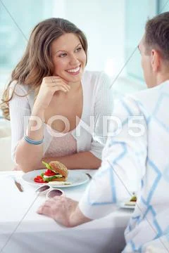 Affectionate couple dining in cafe and communicating Stock Photos