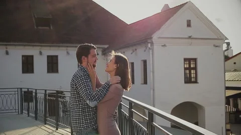 Affectionate couple embracing each other while standing on rooftop Stock Footage 168841206