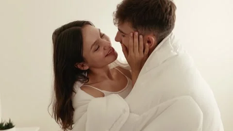 Affectionate Couple Embracing Under White Sheet Together Vidéo 272476836