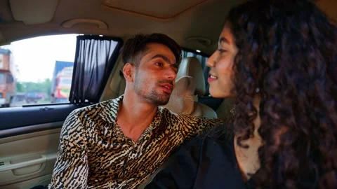 Affectionate couple enjoys light mischief in vehicle Stock Footage 311147568