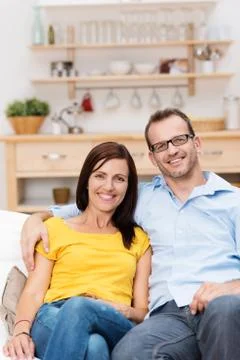 Affectionate couple relaxing on a sofa Stock Photos