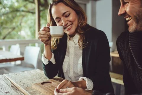 Affectionate couple sitting at a cafe Stock Photos