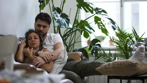 Affectionate couple on sofa embracing each other Spbd. enjoying pleasant good Stock Footage 128286991