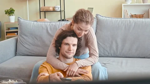 Affectionate Couple Watching TV on Weekend Stock Footage 232936041