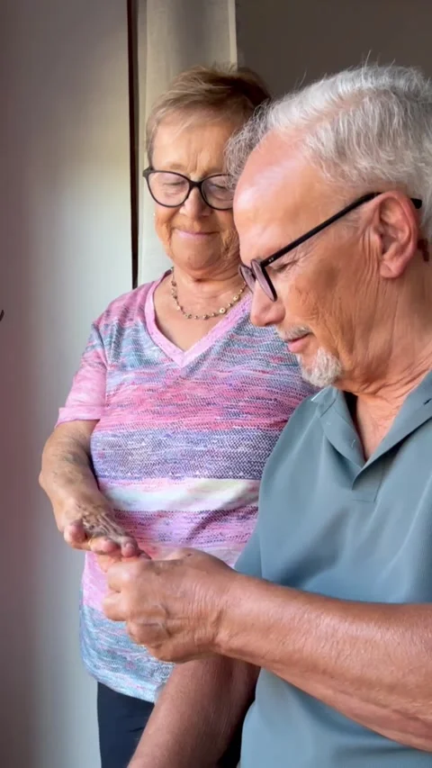 Affectionate elderly couple celebrating their anniversary as the husband Stock Footage 344250408