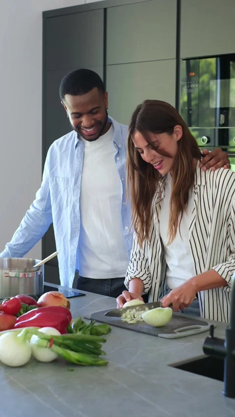 Affectionate interracial couple cooking together Video stock 334636479