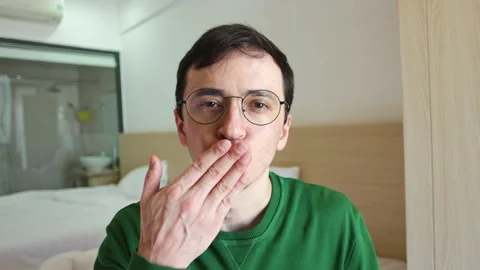 Affectionate man in eyeglasses blowing a kiss Video stock 337366347