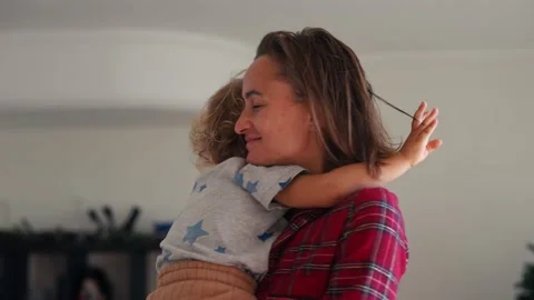 Affectionate mother and son embracing at home Stock Footage 228876393