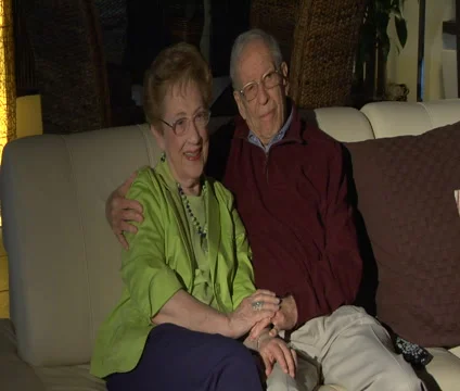 Affectionate Older couple watching TV Stock Footage