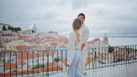 Affectionate pair strolling rooftop admiring city views together. Happy partners Fotos Stock