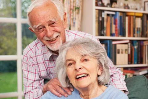 Affectionate Senior Couple At Home Together Stock Photos