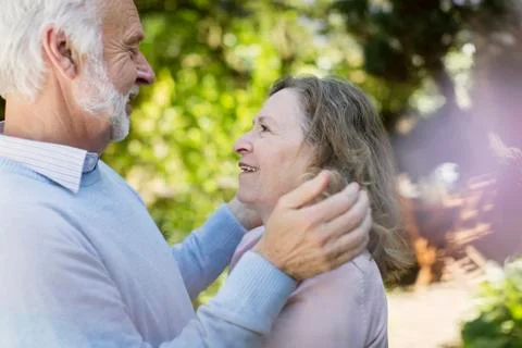 Affectionate senior couple hugging Stock Photos