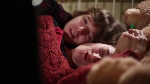 Affectionate Young Couple Snuggle in Bed With a Movie Stock Footage 72202309