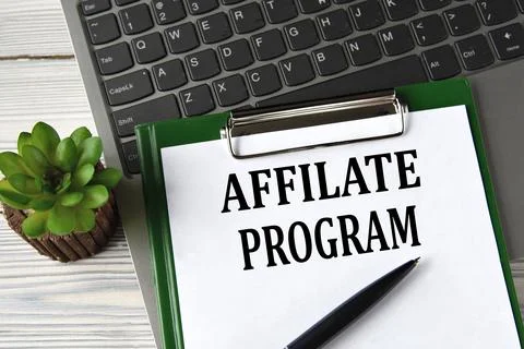 AFFILATE PROGRAM - words on a white sheet on the background of a laptop and a Stock Photos