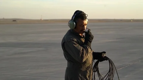 Afghan Air Force ground crew carrying cable Stock Footage 103586760