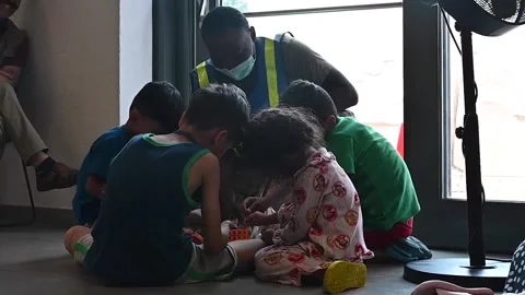Afghan child evacuees playing Stock Footage 160106599