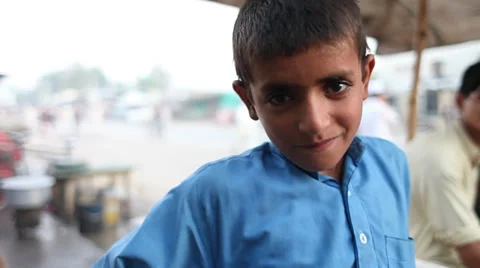 Afghan child looking at camera, then smiles Stock Footage 37755184