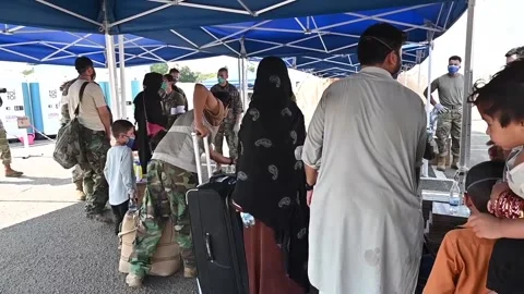 Afghan evacuees queue to have temperature taken on arrival at Ramstein Air Base, Video stock 160106552