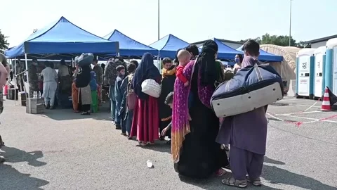 Afghan evacuees queue for processing on arrival at Ramstein Air Base, Germany Stock Footage 160106543