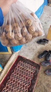 Afghan Man: Walnuts in Plastic Bag, Village Bounty Stock Photos