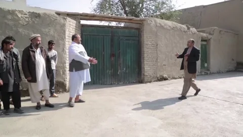 Afghan men greet one another with kisses and handshakes Stock Footage 91969921