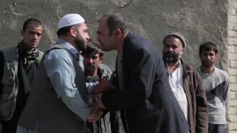 Afghan men greet one another with kisses and handshakes Stock Footage 91969942