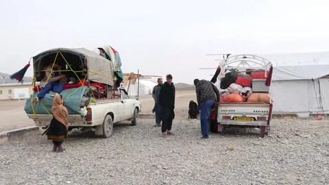 Afghans deported from Pakistan arrive at temporary shelter in Kandahar, KANDAHAR Stock Footage 306466836