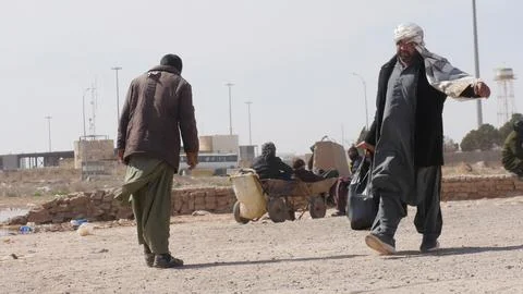 Afghans return from Iran through the Islam Qala border in Herat, Afghanistan - 1 Stock Photos