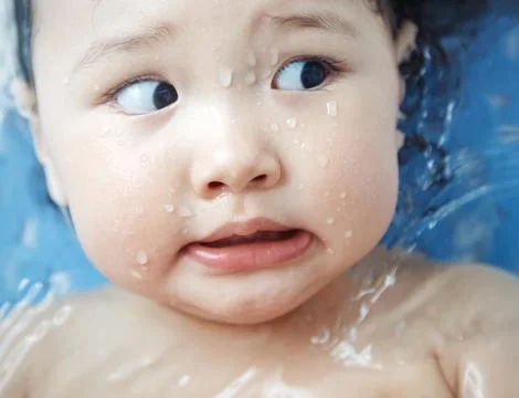 Afraid child in the bath Stock Photos