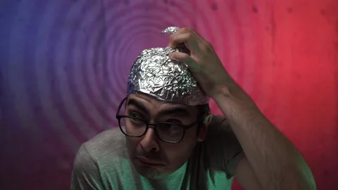 Afraid Paranoid Men Putting a Tin Foil Aluminium Hat on His Head Stock-Footage 136131654