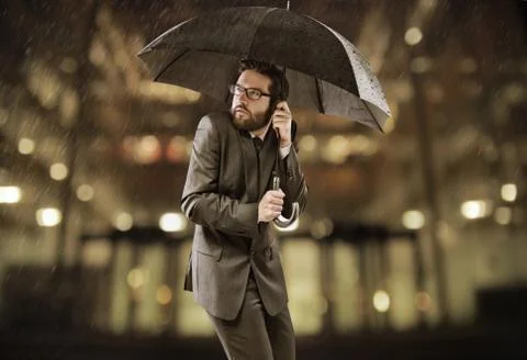Afraid smart manager standing under the umbrella Stock Photos
